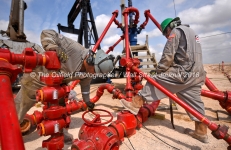 Cudd Energy employees work near a wellhead at a Cudd Energy fracking operation on a Fasken Oil and Ranch well May 22, 2018, in Midland, Texas. CREDIT: TheOilfieldPhotographer.com