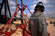 David Cantu, line boss, walks near a wellhead at a Cudd Energy fracking operation on a Fasken Oil and Ranch well May 22, 2018, in Midland, Texas. CREDIT: TheOilfieldPhotographer.com
